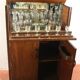 Walnut cocktail cabinet with glasses