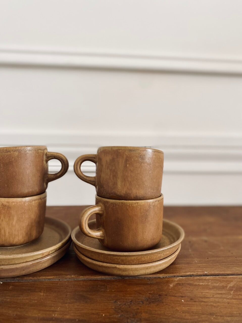 4 stoneware coffee cups and saucers
