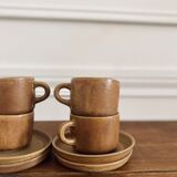 4 stoneware coffee cups and saucers