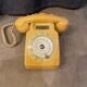 Old dial telephone from the 80s temat quimper bakelite yellow and beige