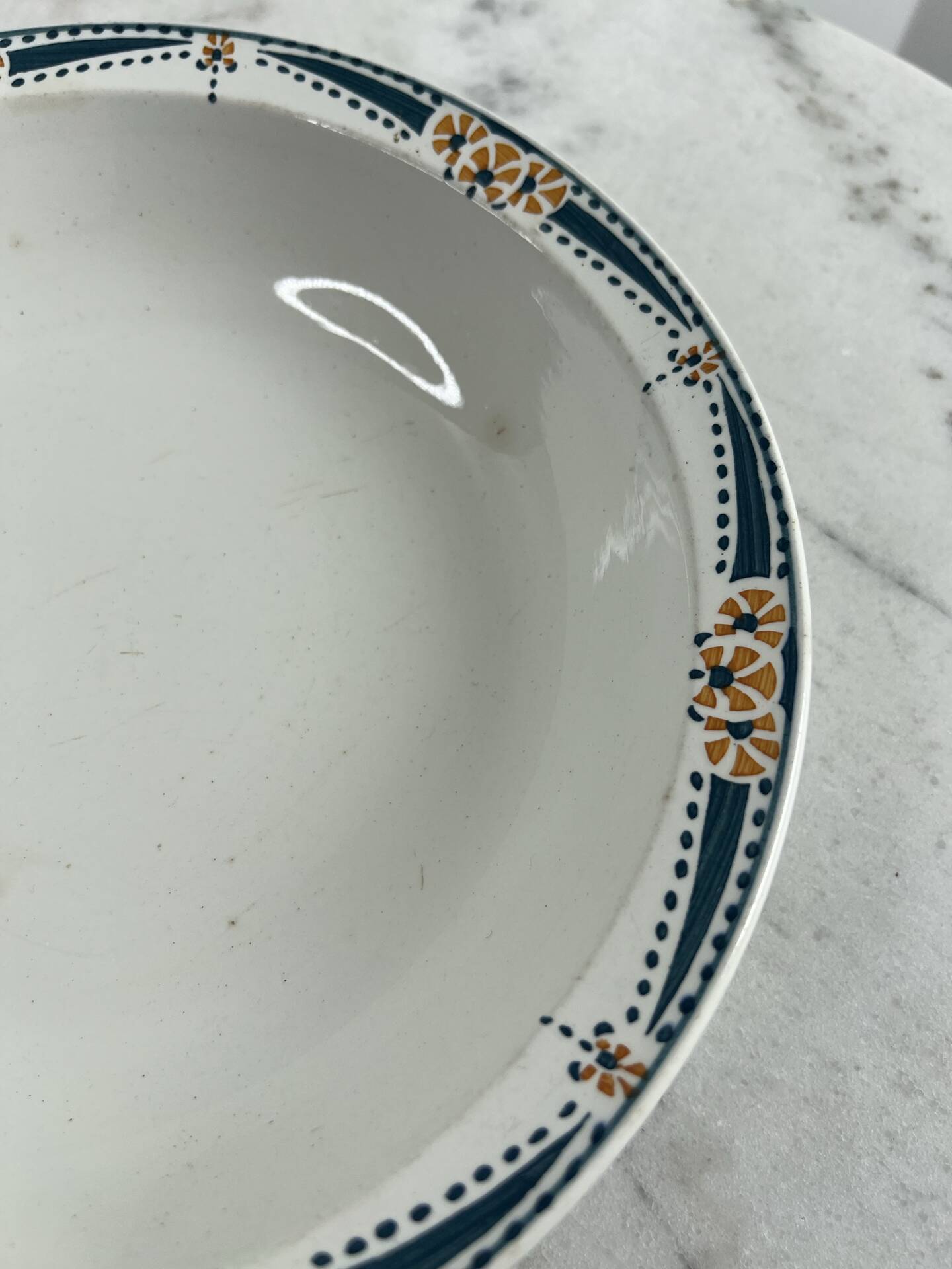 Longwy salad bowl with blue and orange floral decoration.