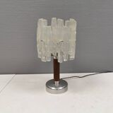 Table lamp with a teak ‘trunk’, silver-coloured metal base, acrylic shade