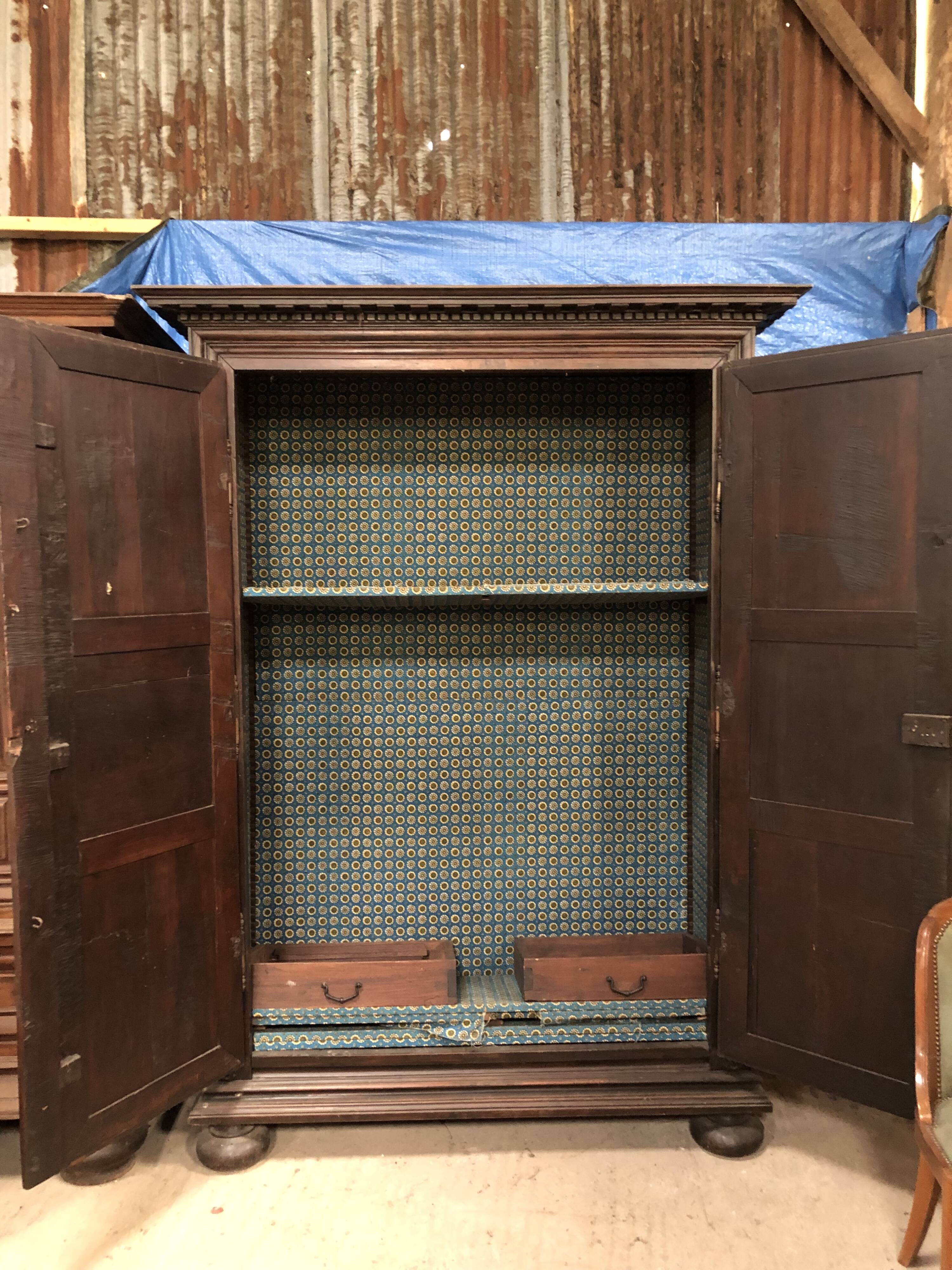 Antique Louis XIII armoire in solid walnut with carved doors