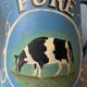 Old painted sheet metal jug or milk jug