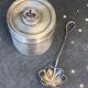 Sprinkling spoon and art deco sugar pot in silver metal