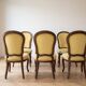 Set of 6 antique classic style chairs in wood and yellow fabric.
