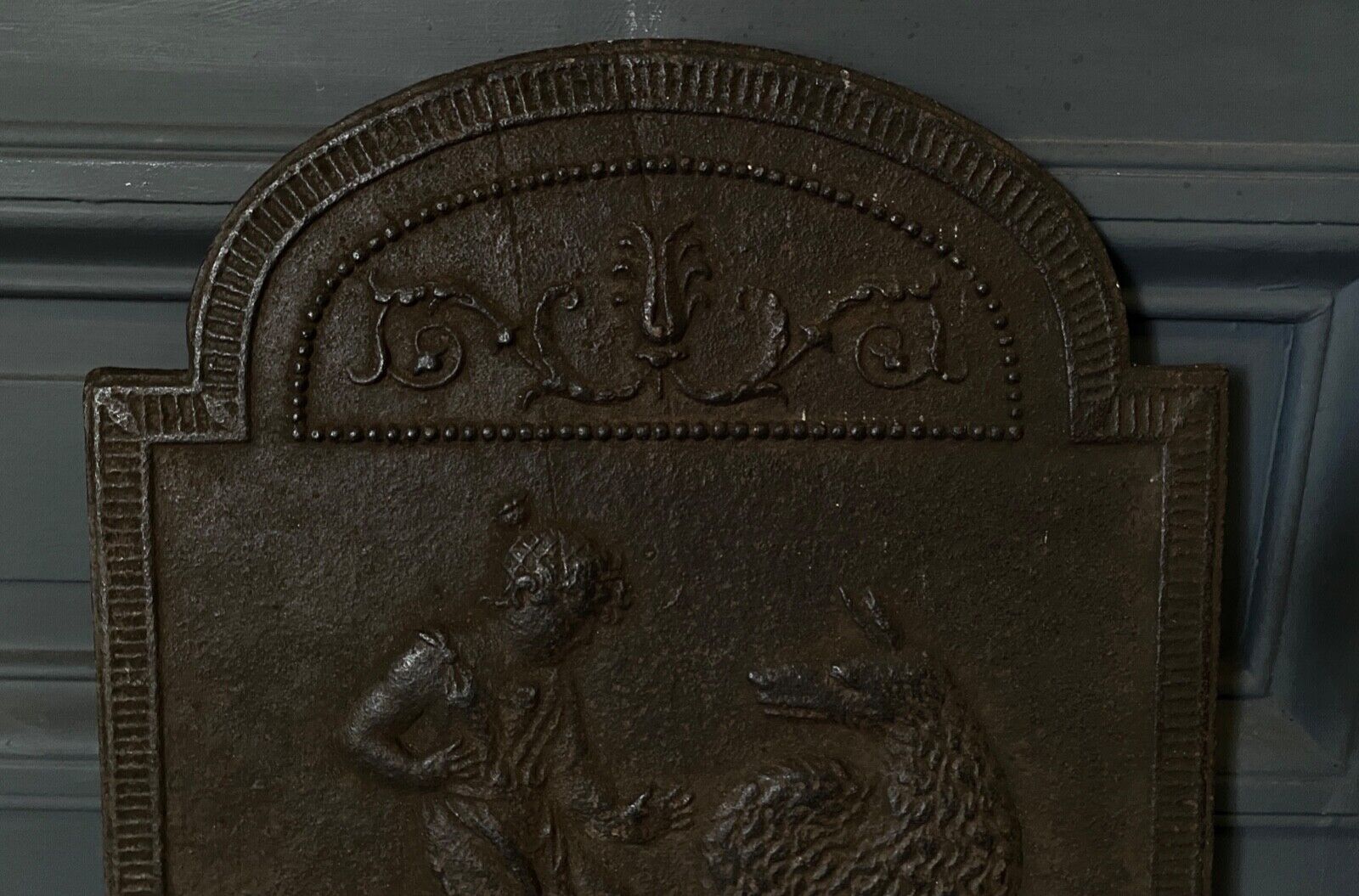 EIGHTEENTH CENTURY CAST IRON FIREPLACE PLATE REPRESENTING A WOMAN AND A WOLF