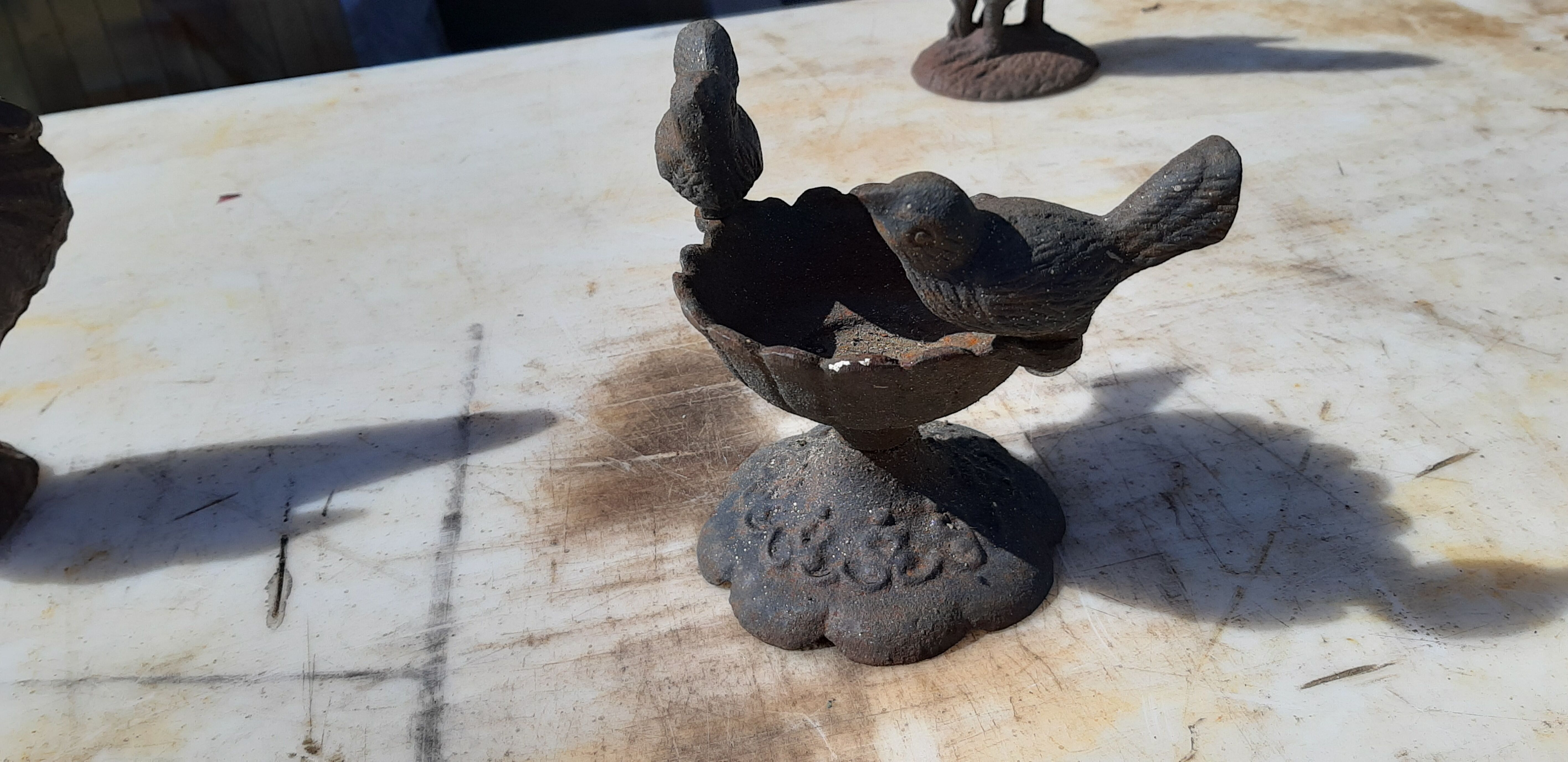 2 roosters and 2 cast iron birds