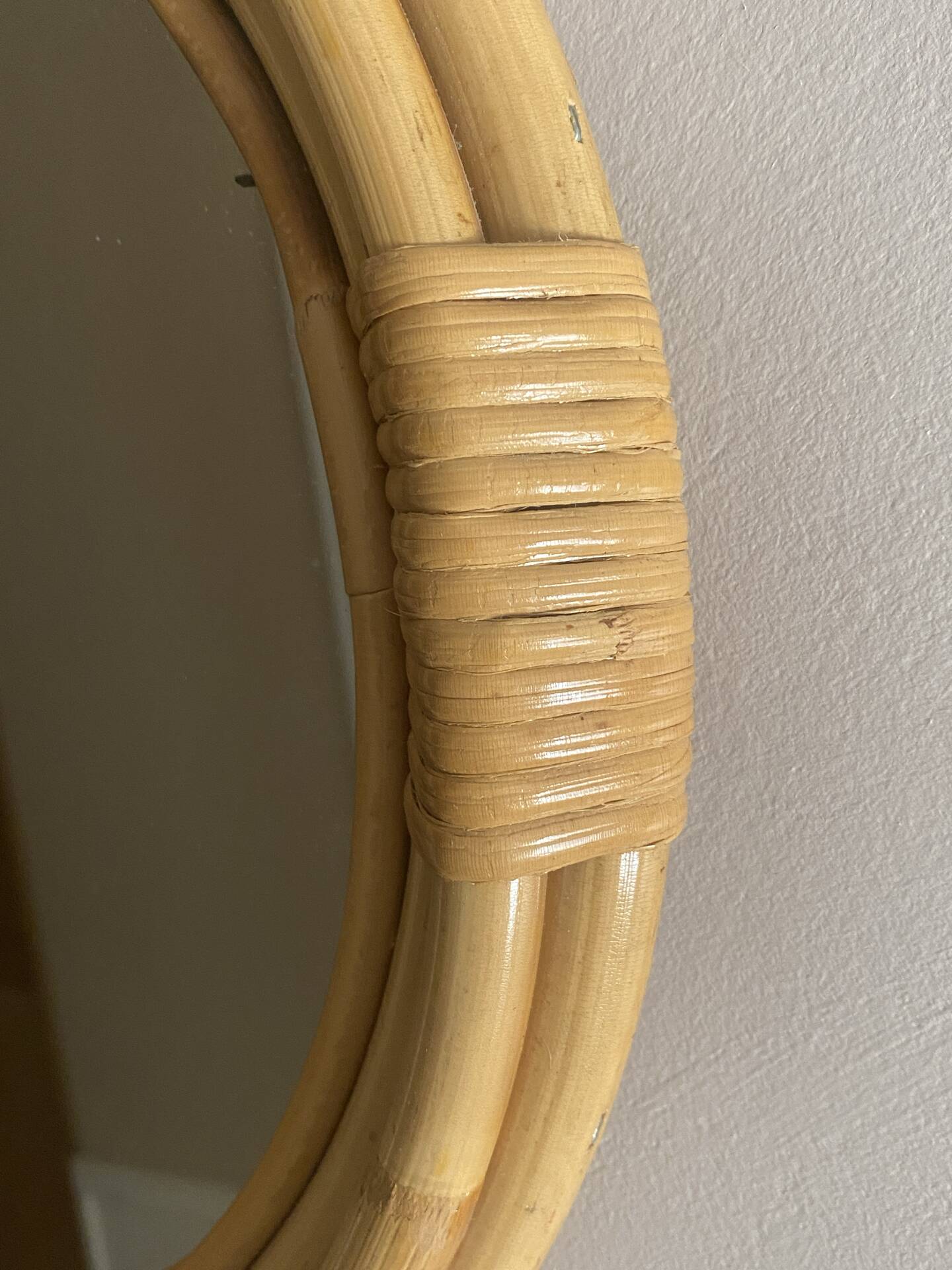 Round mirror from the 1960s with a frame made of rattan and metal.