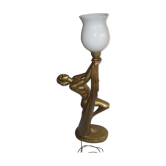 Lamp depicting a with a drape
