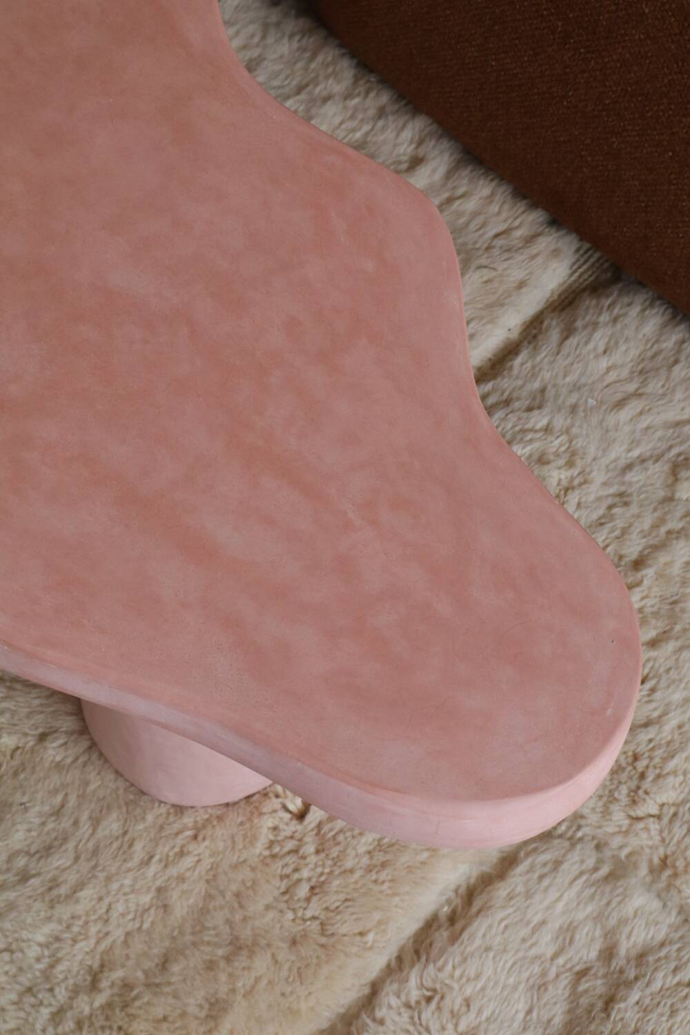 Organic shaped coffee table in pink teracotta tadelakt