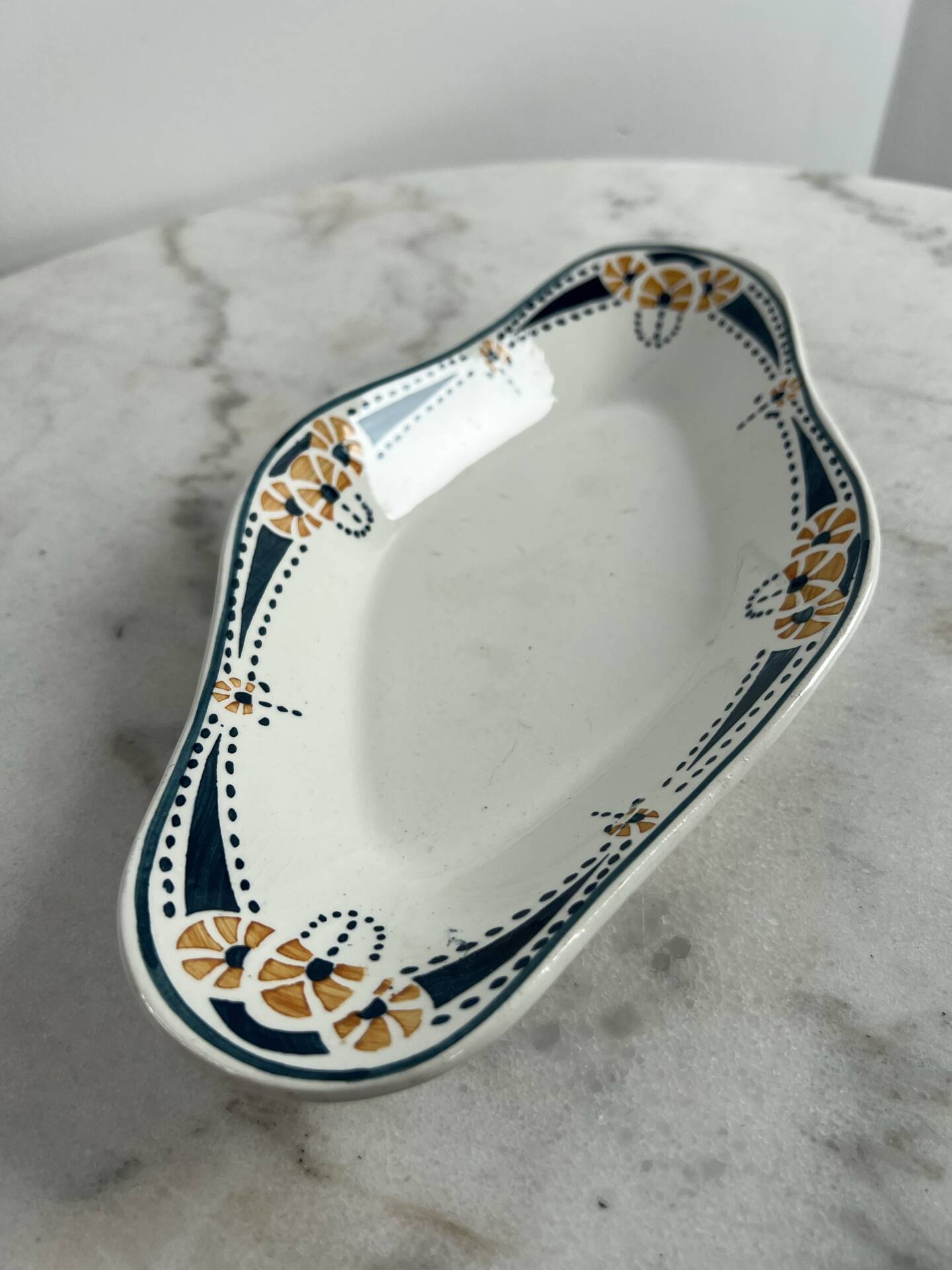 Longwy ramekin with blue and orange floral decoration.