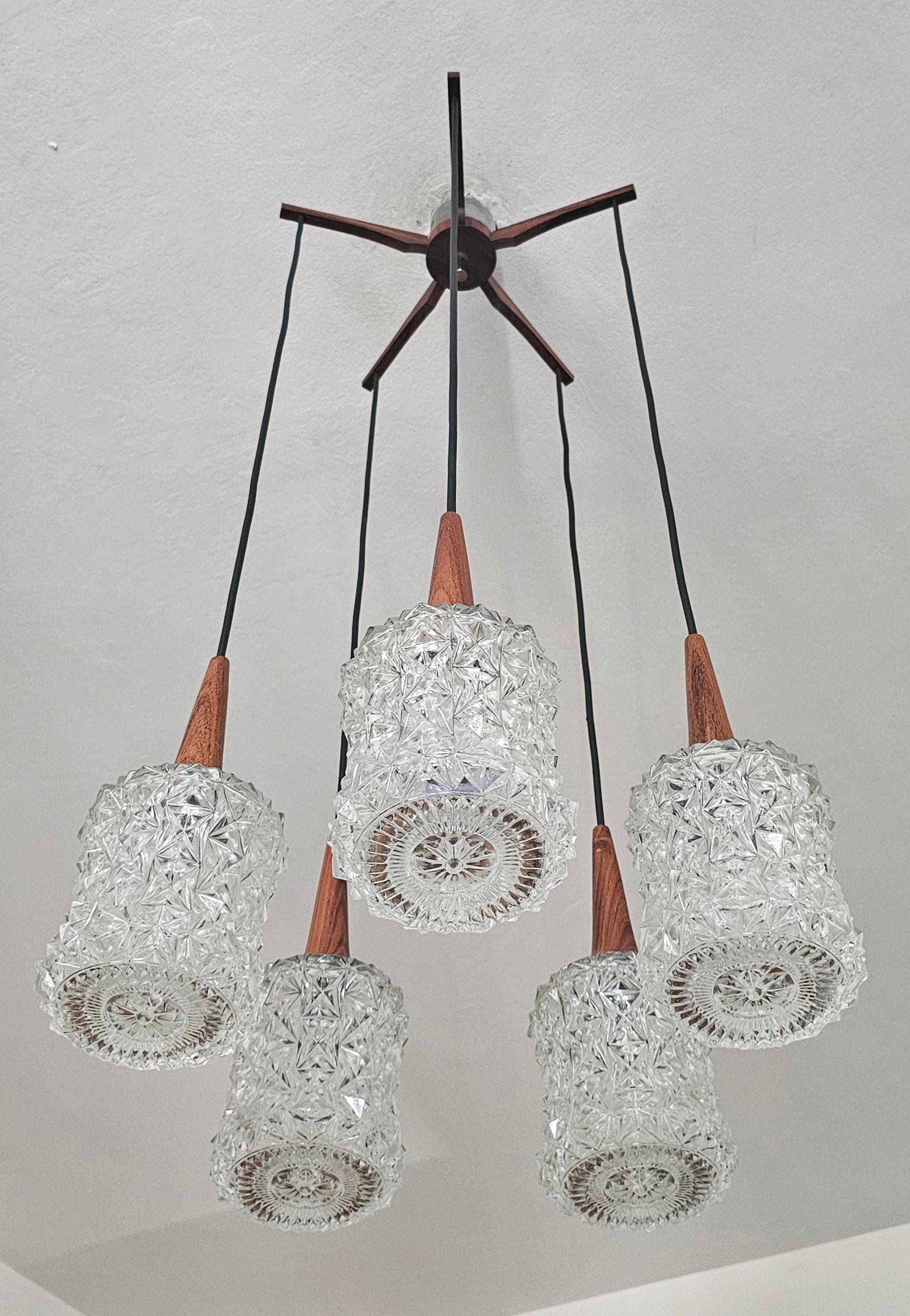 Mid Century Modern spider chandelier in teak, rosewood, and crystal.