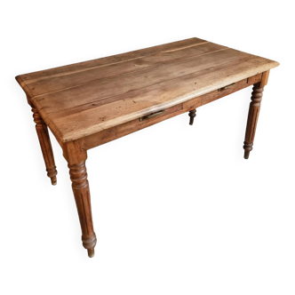 Antique French oak table with drawers, circa 1900.
