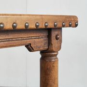 Brutalist coffee table in solid oak, metal, and patinated leather, 1940s.