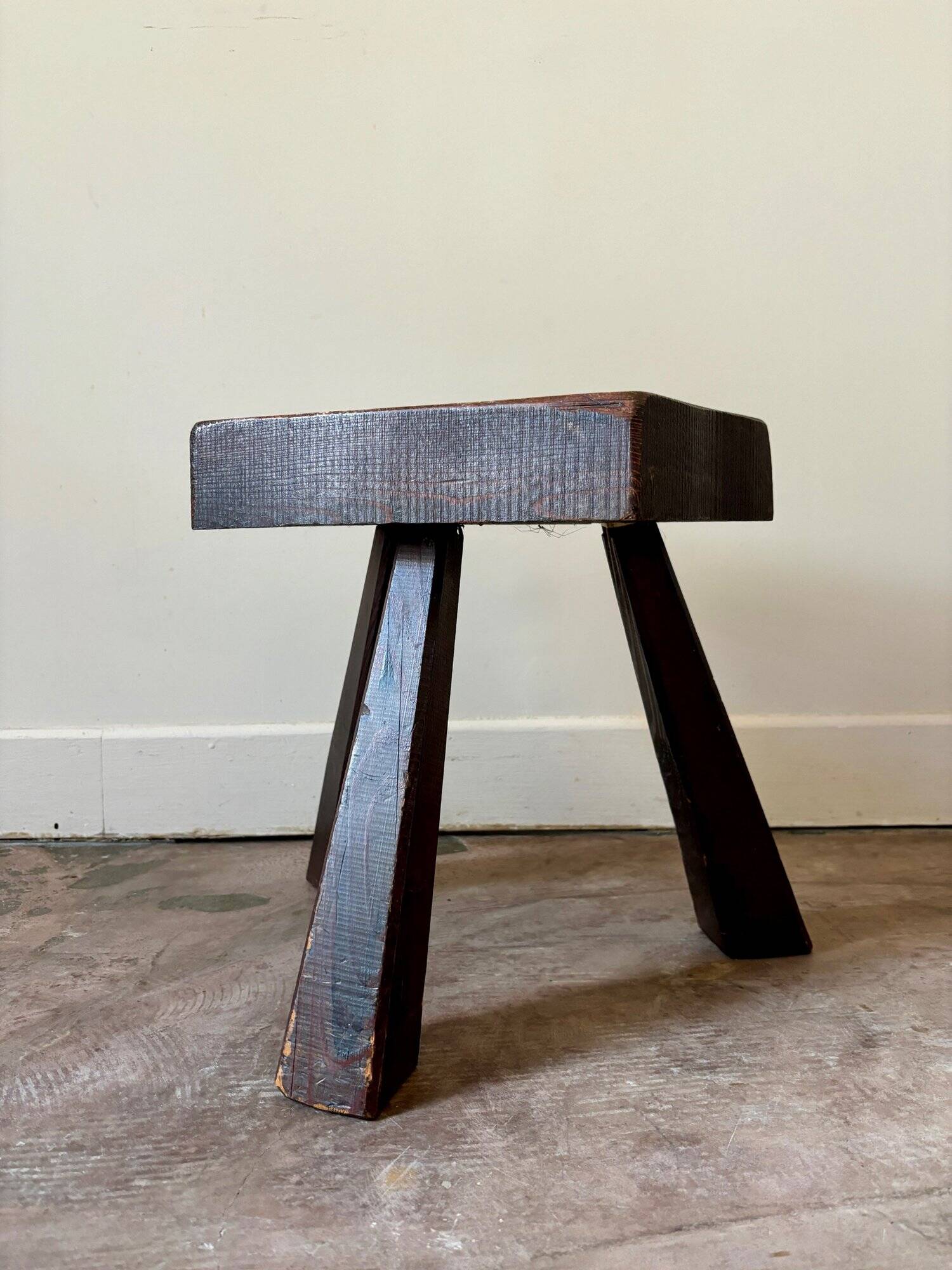 Brutalist tripod stool in dark wood