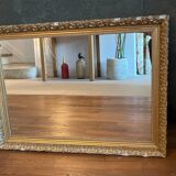Antique mirror with a wooden and gilded stucco frame.