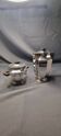 Coffee creamer with a silver metal sugar bowl.