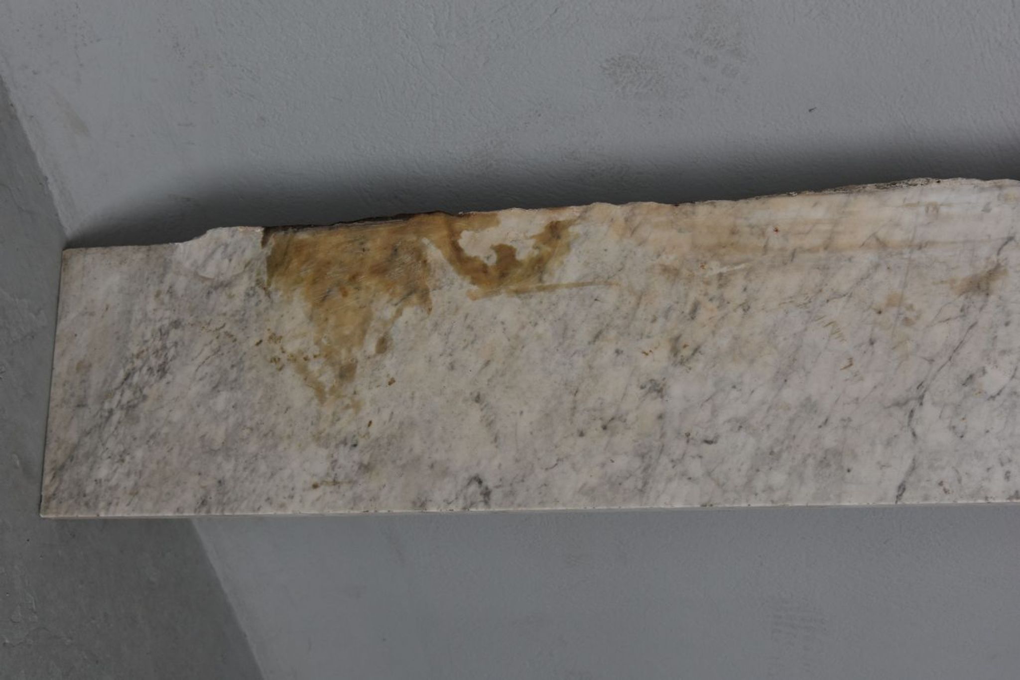 Old fireplace in white marble veined Louis XVI