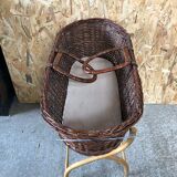 Old woven wicker baby cradle