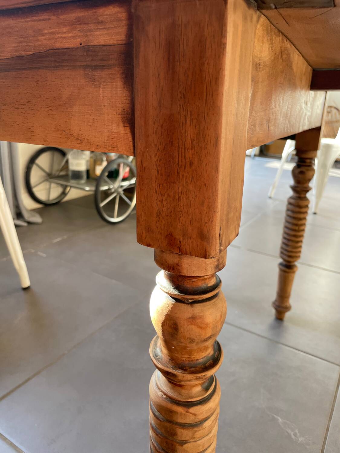 Oval wooden table with drop-leaf edges.