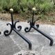 Massive wrought iron chenets from the 19th century topped with brass balls.