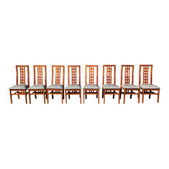 Set of 8 teak lounge chairs with high backs and zebra-striped seats