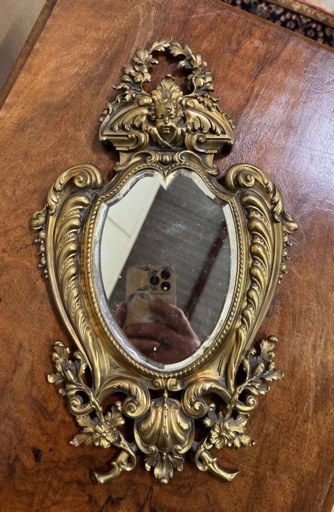 Mirror in the Louis XV Rocaille style in gilded bronze.