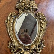 Mirror in the Louis XV Rocaille style in gilded bronze.