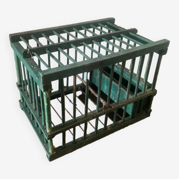 old bird cage made of wood and painted green