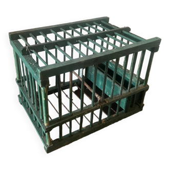 old bird cage made of wood and painted green
