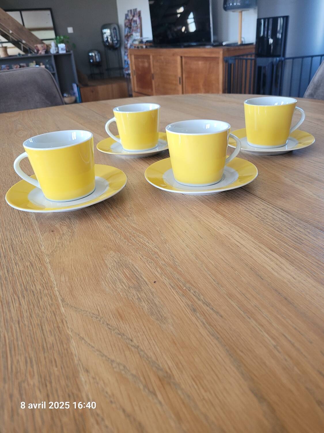 4 yellow and white cups and saucers