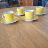 4 yellow and white cups and saucers