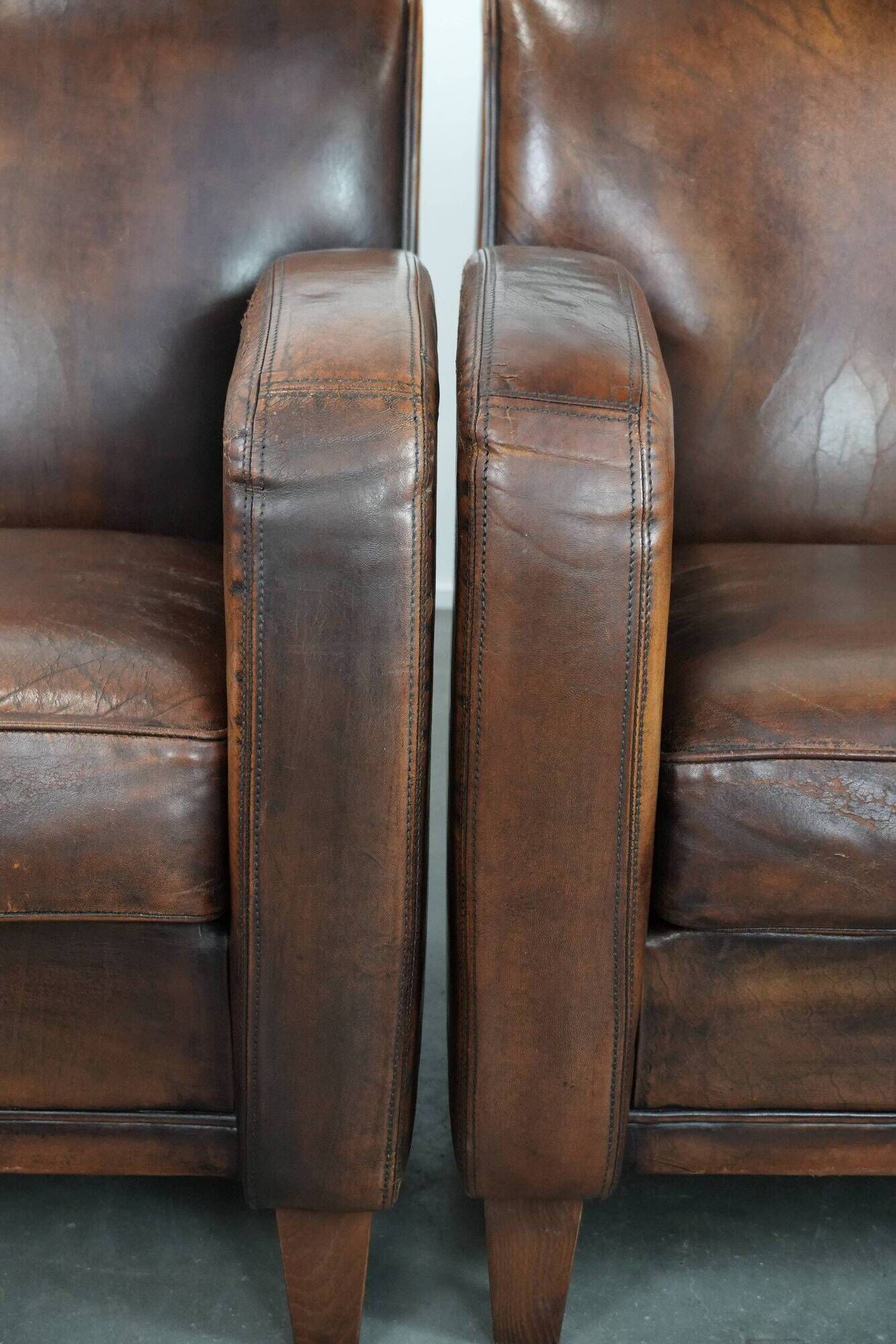 Characterful set of two vintage sheepskin armchairs with beautiful colours