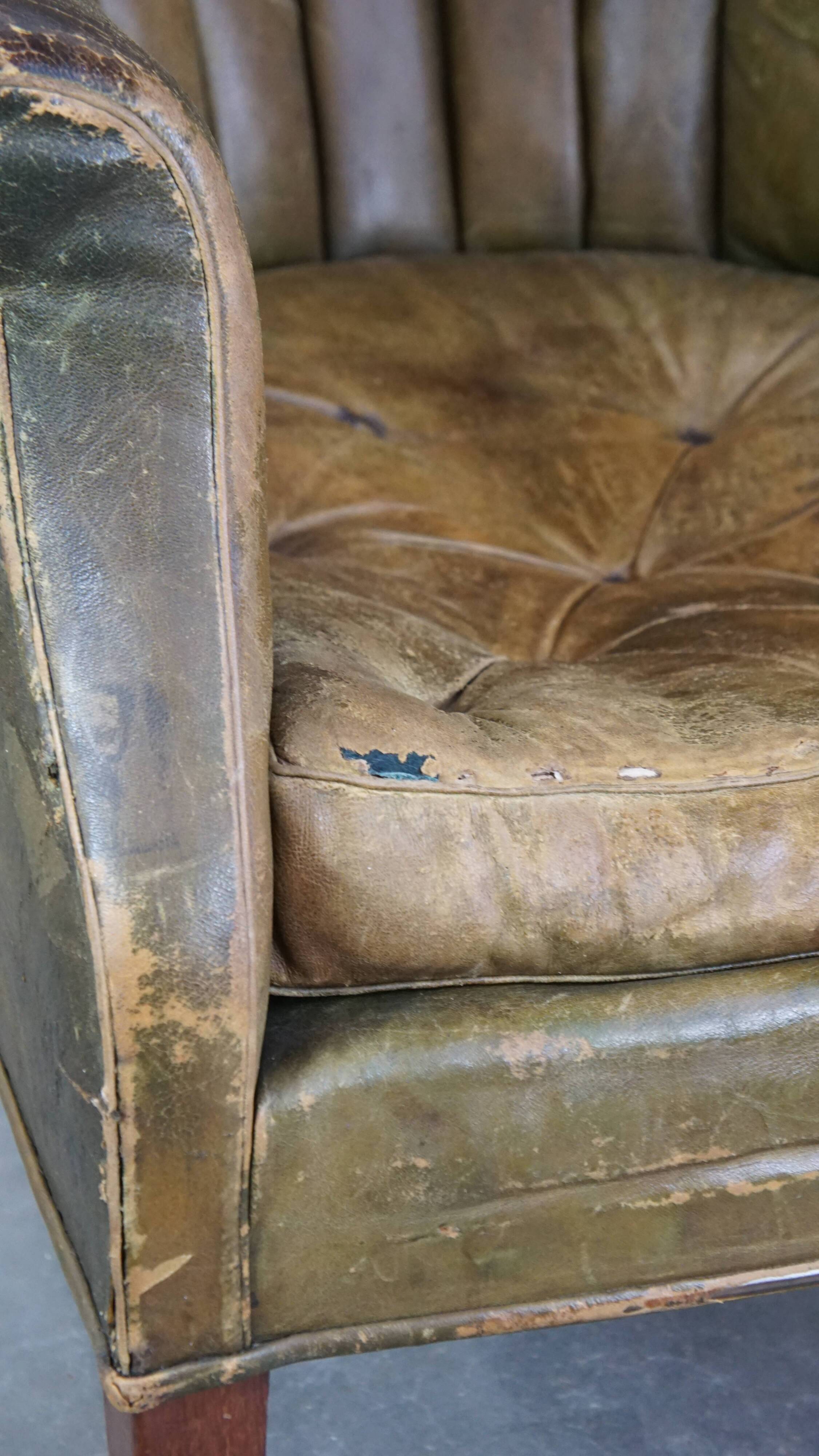 Green antique barrel back wingback chair on wheels