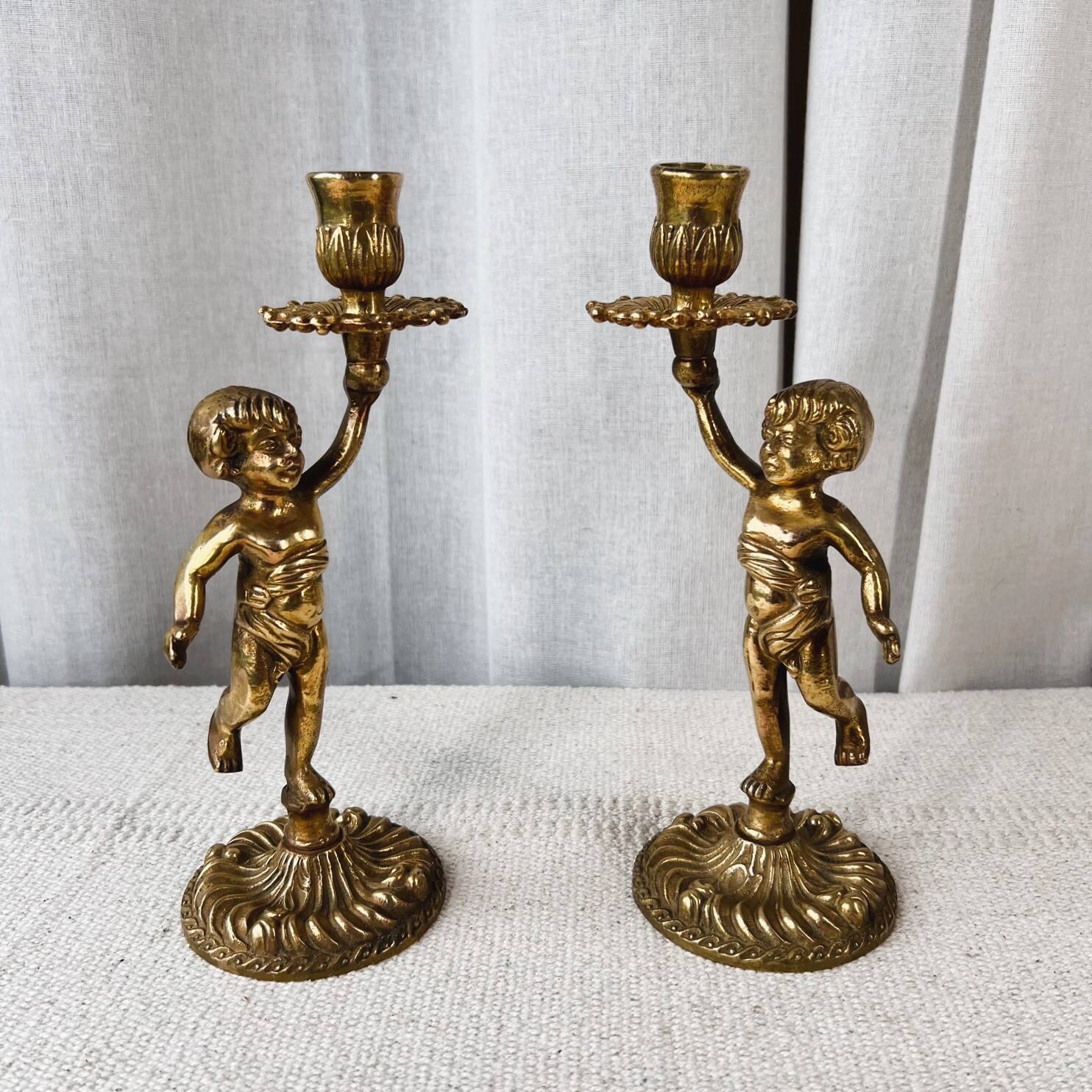 Pair of bronze “Cherubim” candlesticks