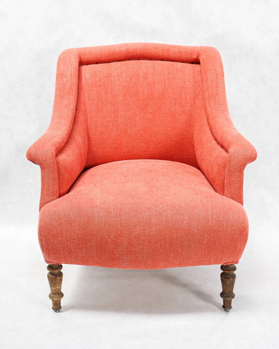 Napoleon III salon armchair in brick red linen with a tufted footrest.