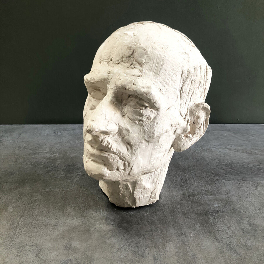 Head of a man with a plaster mustache