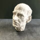Head of a man with a plaster mustache