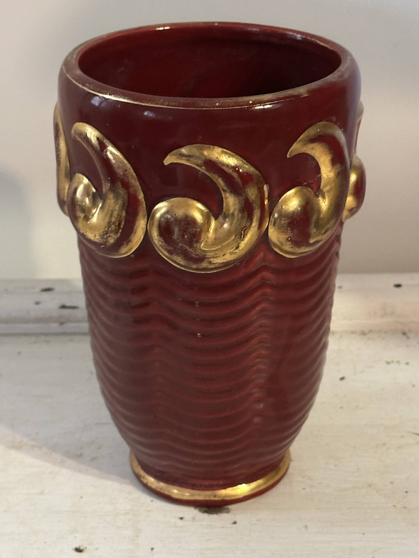 Mid-century relief vase in ruby red enhanced with gilding.