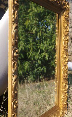 Wooden mirror decorated with gold from the 1920s
