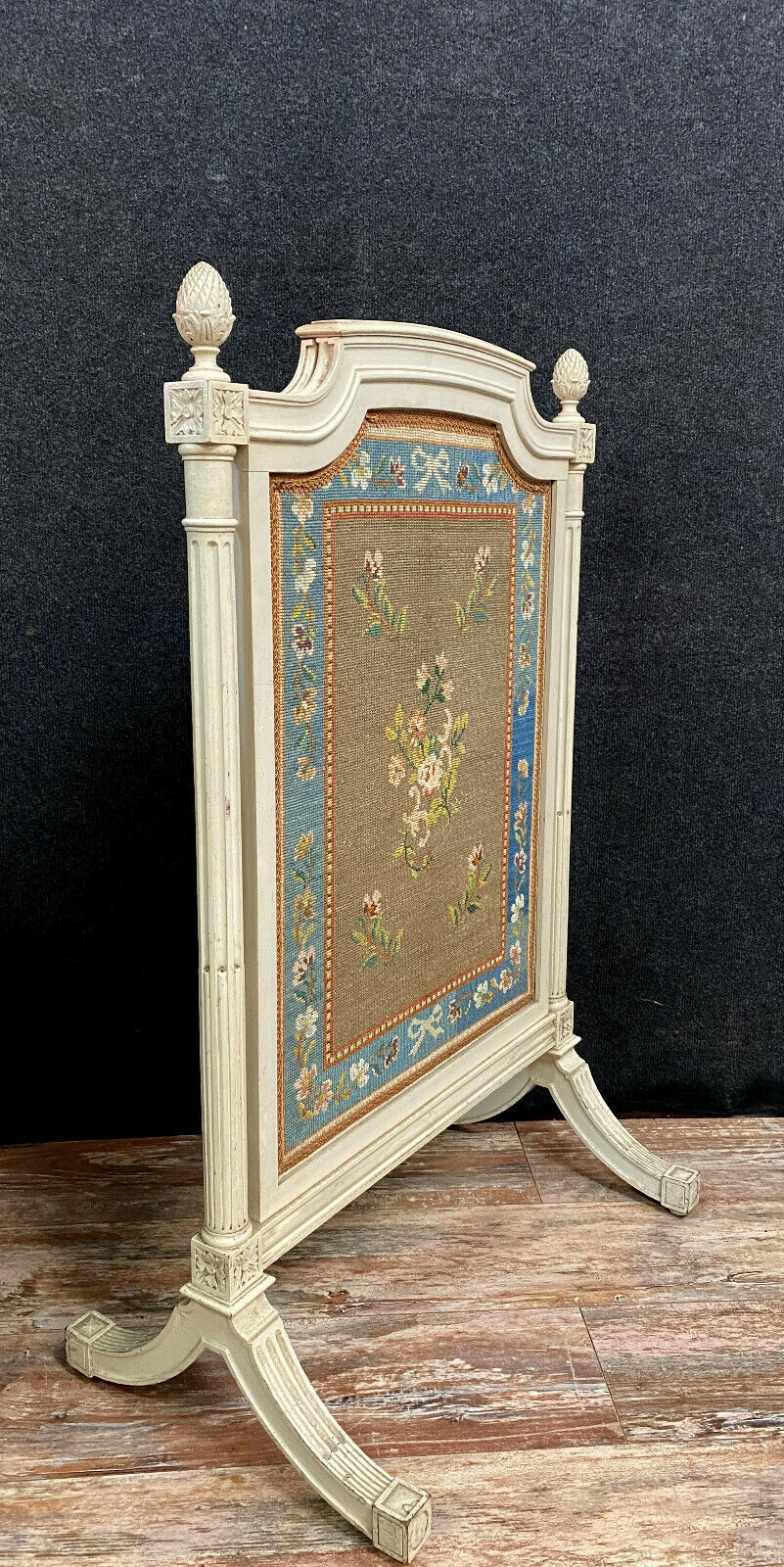 Front of Louis XVI fireplace in laqué wood and fabric has floral decorations