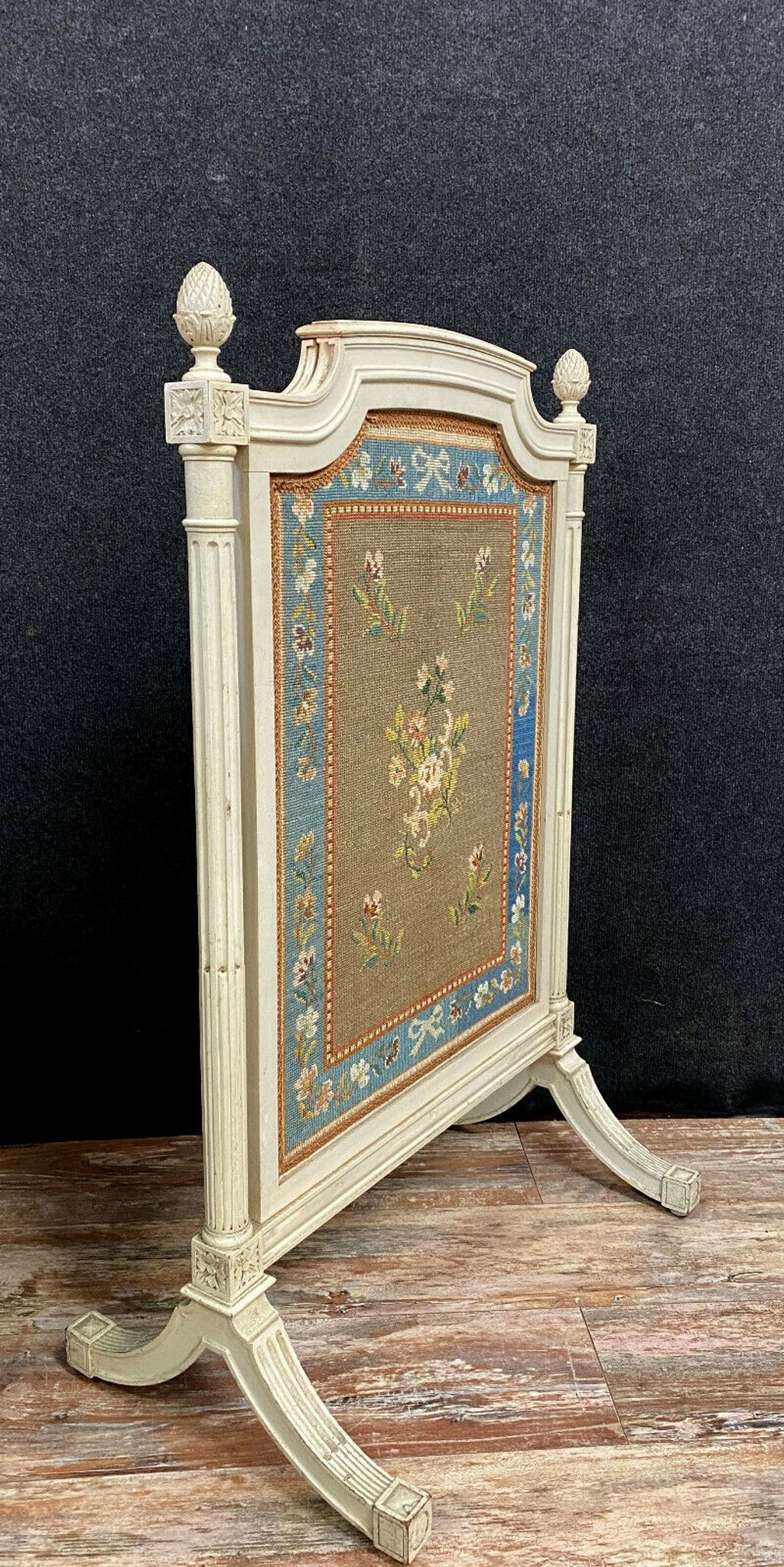 Front of Louis XVI fireplace in laqué wood and fabric has floral decorations