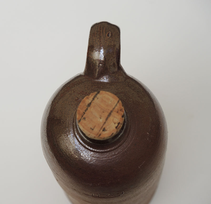Old enamelled brown sandstone bottle with cork stopper