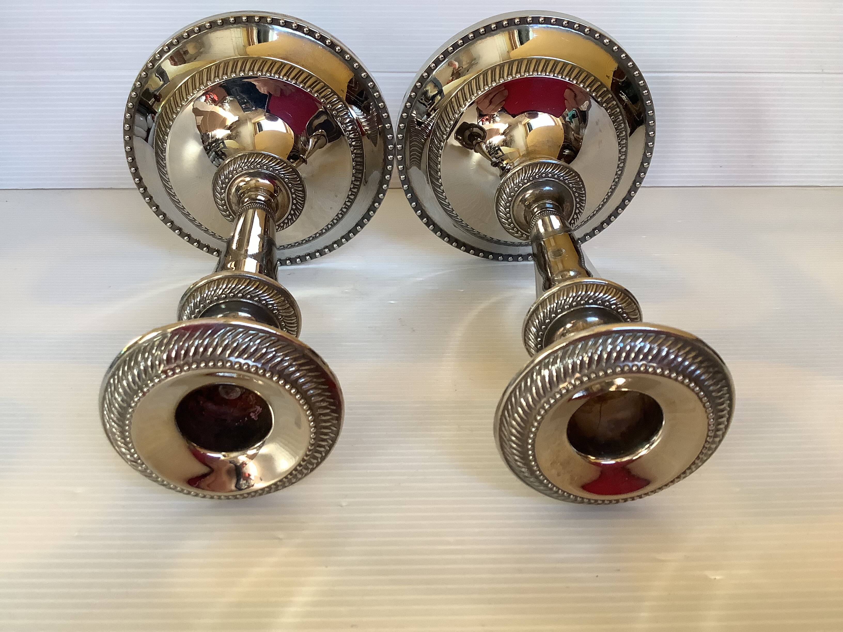 Pair of silver-plated zinc metal candlesticks