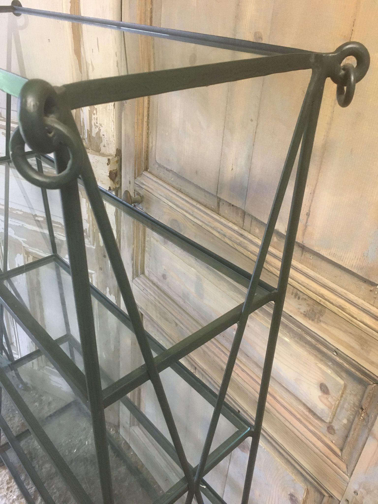 Pair of wrought iron and glass bookshelf shelves.