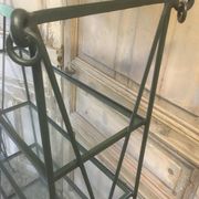Pair of wrought iron and glass bookshelf shelves.