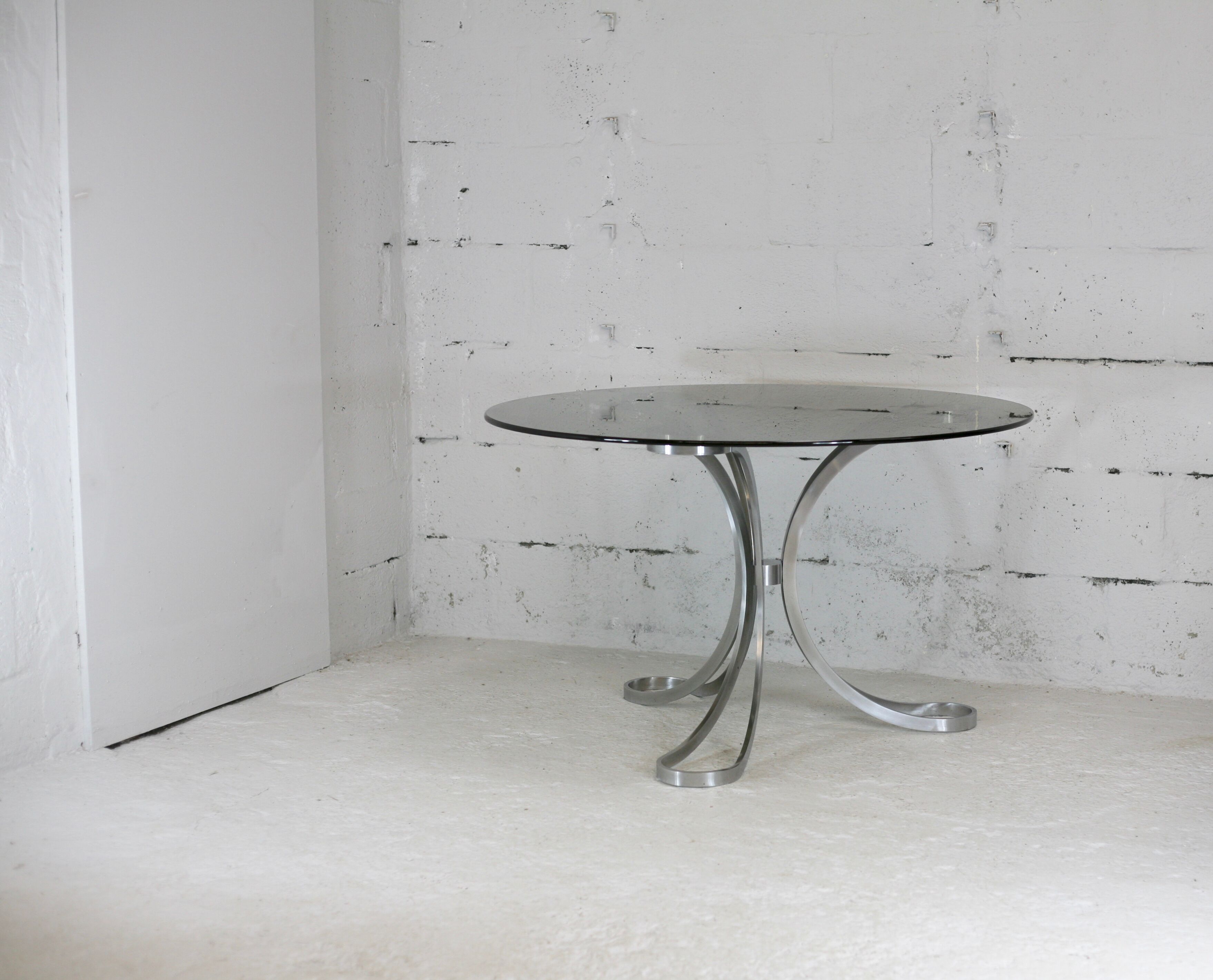 Living room table "Space Age" polished steel, circular slab smoked glass. France, circa 1970.