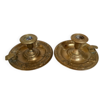 Pair of brass cellar rat candlesticks mascarons