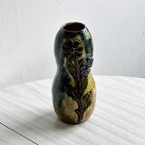 Very colorful glazed earthenware vase, old vase with floral decoration.